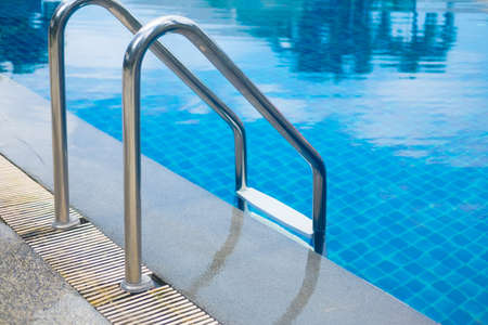Swimming pool with stair at hotel close up