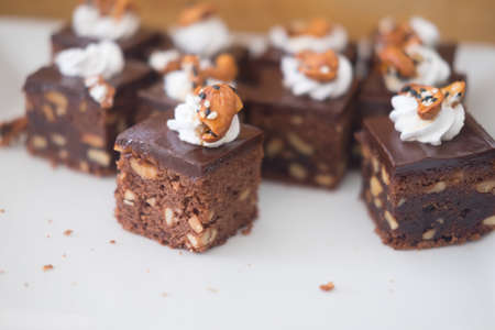 Piece of chocolate brownies on white dish (selective focus)の写真素材