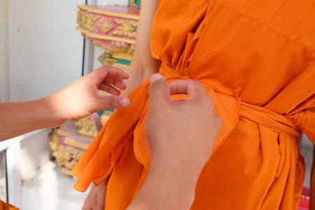 Monk dressing from master to new monk. Thai culture when a man is over 20 years old.