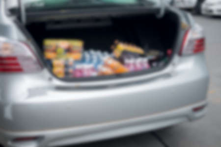Blur background car trunk with various from supermarket (sale, consumerism concept)