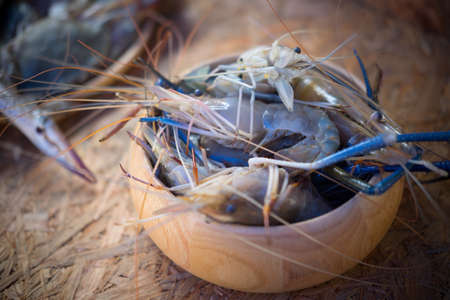 Raw shrimp in wood bowl ready to cook