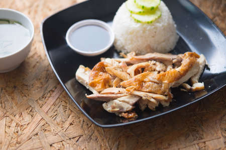 Thai rice with grilled chicken and soup on wood table