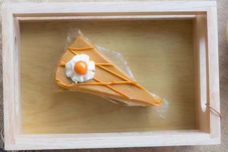 Thai tea cake on wooden plate, sweet and dessertの写真素材