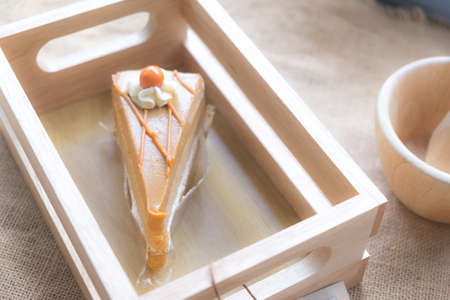 Thai tea cake on wood box in coffee shop