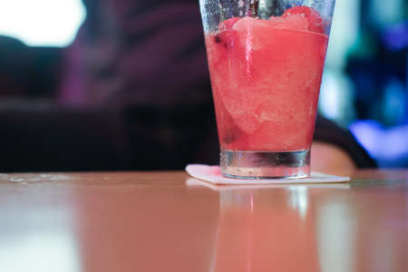 Watermelon smoothie in glass on wood table, selective focusの写真素材