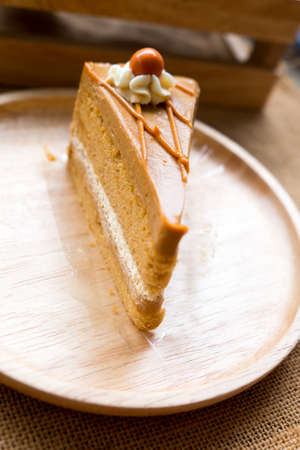 Thai tea layer cake on wood dish ready to eatの写真素材