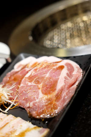 Premium slice raw pork meat for BBQ grill in black trayの写真素材