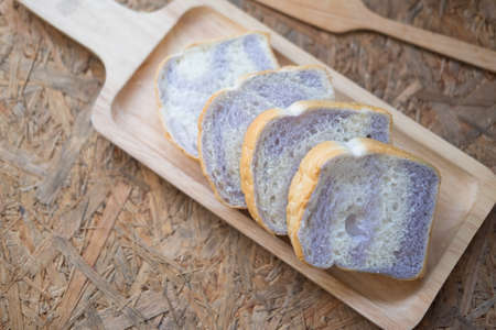 Taro sliced breads in wooden tray on wooden table