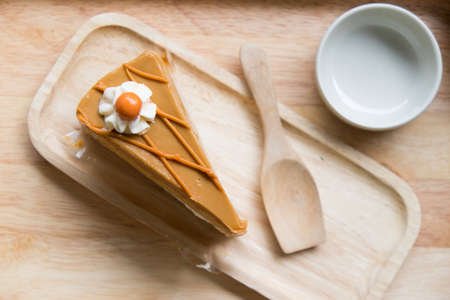 Thai tea cake with small wooden spoon on trayの写真素材