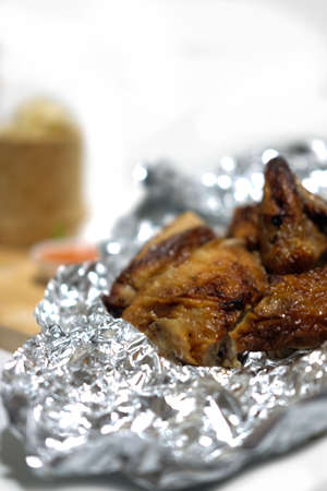 Whole roasted chicken on foil with sticky riceの写真素材