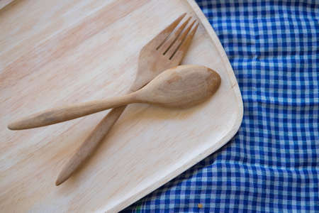 Wooden fork and spoon on wood trayの写真素材
