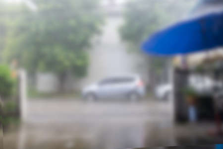 Blurred background raining with car view from homeの写真素材