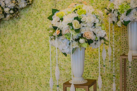 Beautiful decoration artificial rose flower in green and white tone background.の写真素材