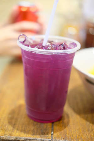 Iced butterfly pea on wood table, refreshment conceptの写真素材
