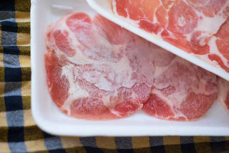 Raw kurobuta pork slices on plates for sukoyaki and yakiniku hot pot shabu japanese foodの写真素材