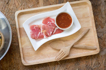 Sukiyaki or Shabu shabu with slide pork  and dip sauce on wood trayの写真素材