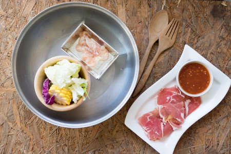 Sliced pork and chicken  with vegetables served in hot pot, set ready to serve for shabu menuの写真素材