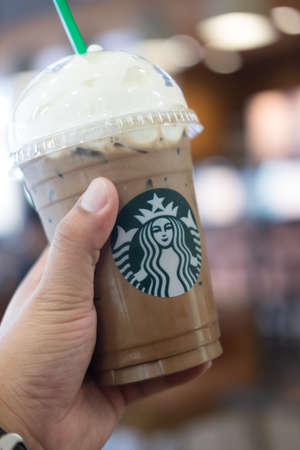Bangkok, Thailand - Aug 19, 2017: Cup of Starbucks ice coffee with whipped cream in Starbucks coffee shop for promotion buy 1 get 1 free in man handのeditorial素材