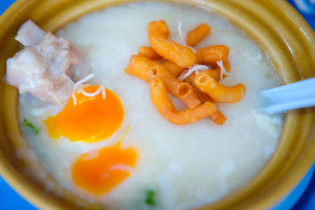 Close up of pork rice porridge served with pork and deep-fried doughstickの写真素材