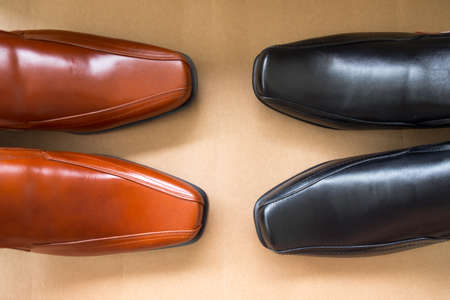 Focus of brown dress shoes against focus of black dress shoes