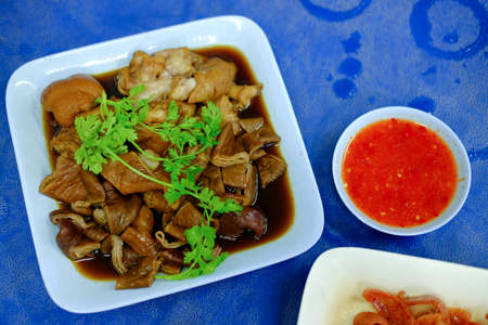 Pork chitterlings in the sweet gravy served with chili sauce, Thai cuisine.の写真素材