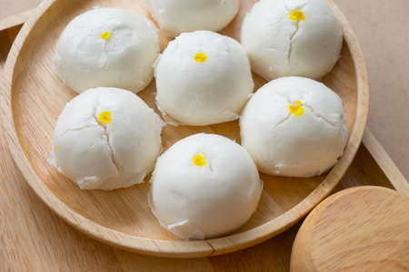 Chinese dumplings (steamed stuffed bun) put on wooden dish