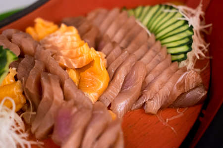 Japanese traditional food Sashimi salmon and tuna on red plateの写真素材