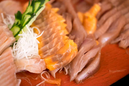 Japanese traditional food Sashimi salmon and tuna on red plateの写真素材