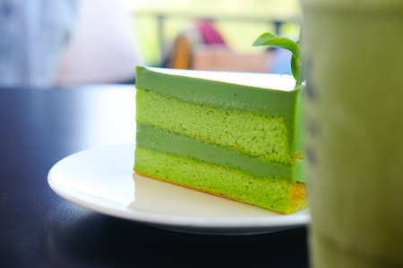 A piece of green tea cake on white dishの写真素材