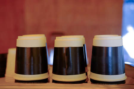 Disposable paper cup for coffee and hot drinks on coffee machine in coffee shop