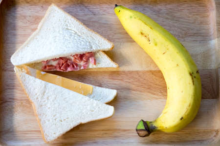 Close up sandwich triangles and fresh banana ready to eat in breakfastの写真素材
