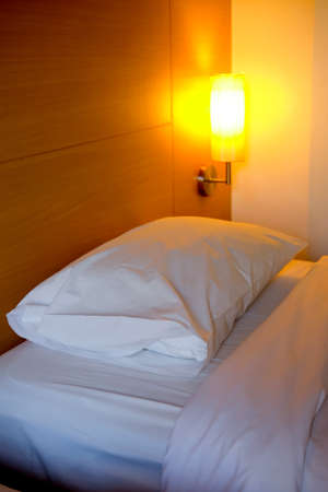 Close up white bed in a room hotelの写真素材