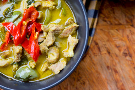 Thai food (Kaeng Khiao Wan) green curry with pork on wooden backgroundの写真素材