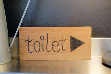 Sign of toilet written on a wooden board, selective focusの写真素材