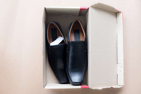 Black elegant men's shoes in paper boxの写真素材