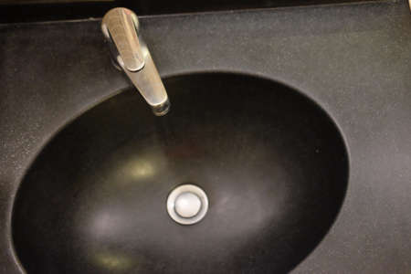 Close up of a modern black sink in modern bathroomの写真素材