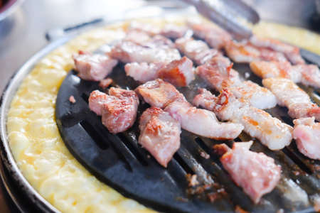 Barbecue beef on bbq pit during korean meal set in restaurantの写真素材