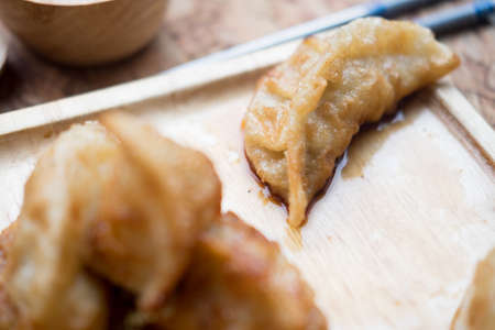 Fried dumplings on wooden plate close upの写真素材