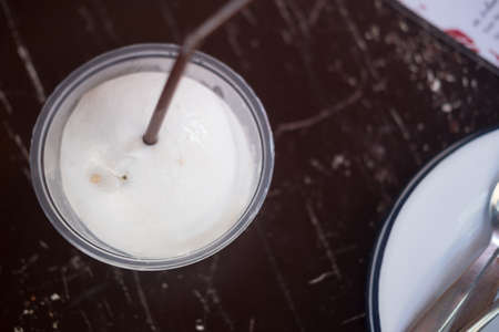 Drinking sweet coconut water on wooden table