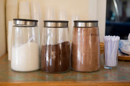 Jar of coffee, sugar and cocoa in buffer at hotelの写真素材