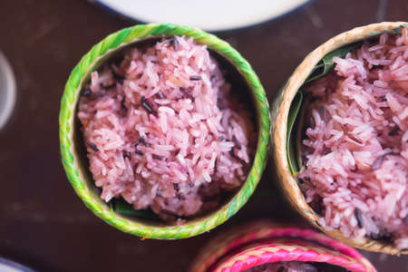 Dark sticky rice inside bamboo container, top viewの写真素材