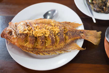 Deep fried ruby fish with garlic, top viewの写真素材