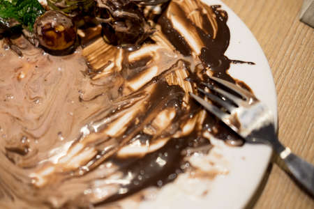Empty and dirty white plate after eating dessertの写真素材