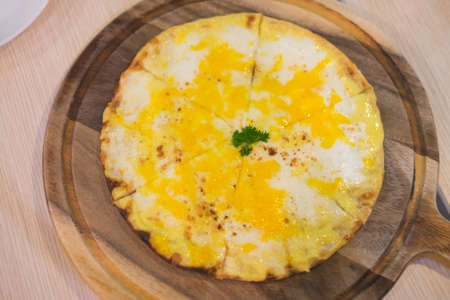 Delicious Homemade Cheese pizza tarte on wooden boardの写真素材