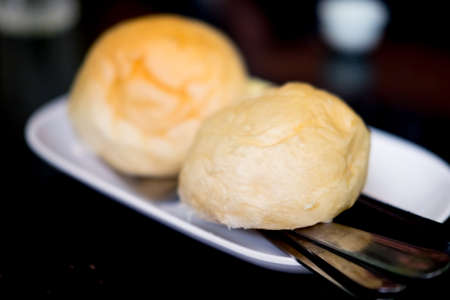 Fresh round bread at the restaurant table.の写真素材