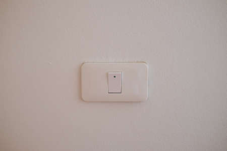 White power switch on cement wall