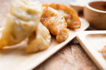 Gyoza dumplings in wooden plate, popular japanese foodの写真素材