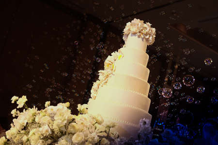 White floral wedding cake with bubble at wedding receptionの写真素材
