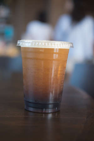 Iced black coffee on wooden tableの写真素材