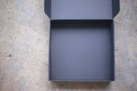 Paper black box mockup on cement floor